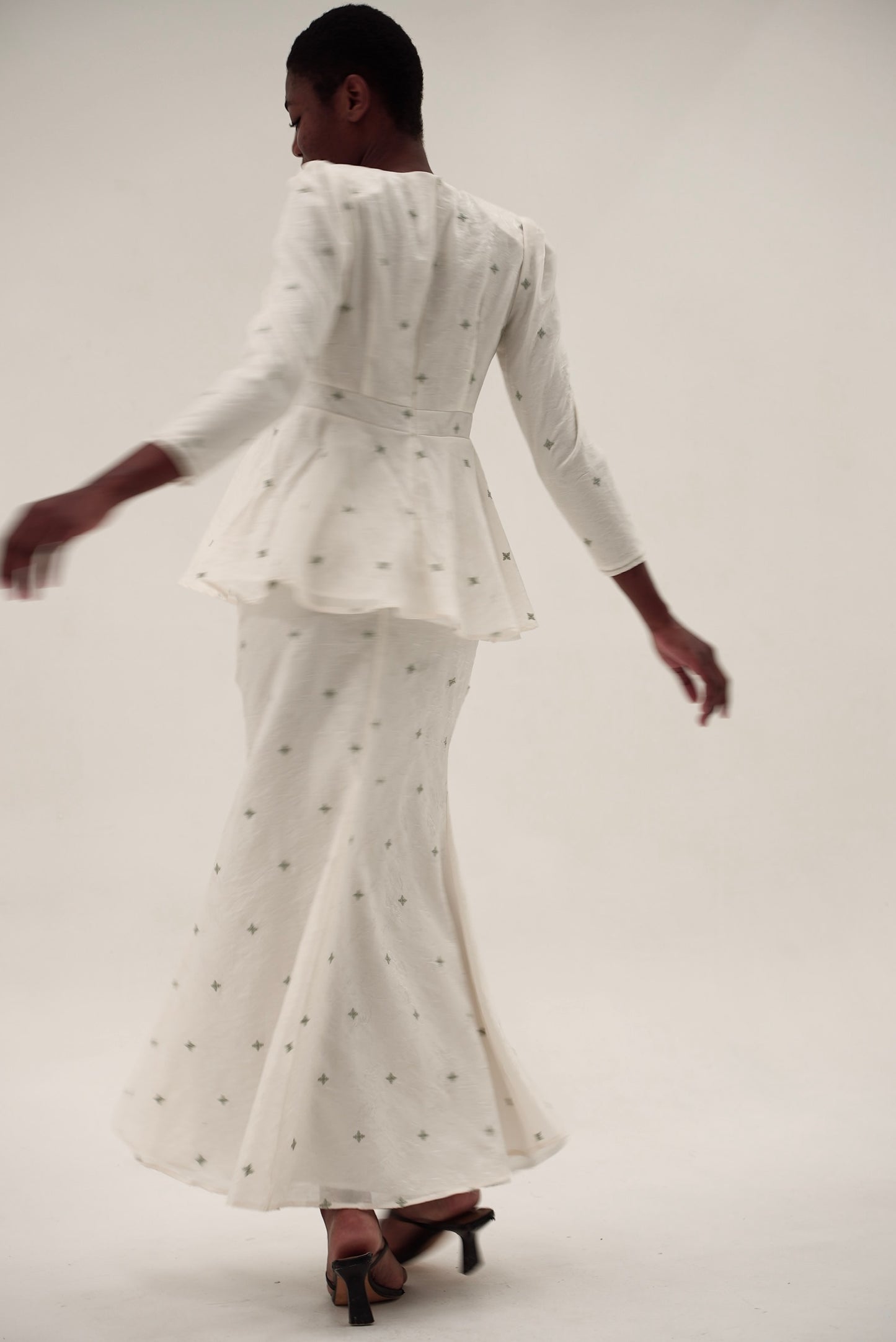 Kurung Lara peplum kurung set in motion with flowing skirt and structured bodice
