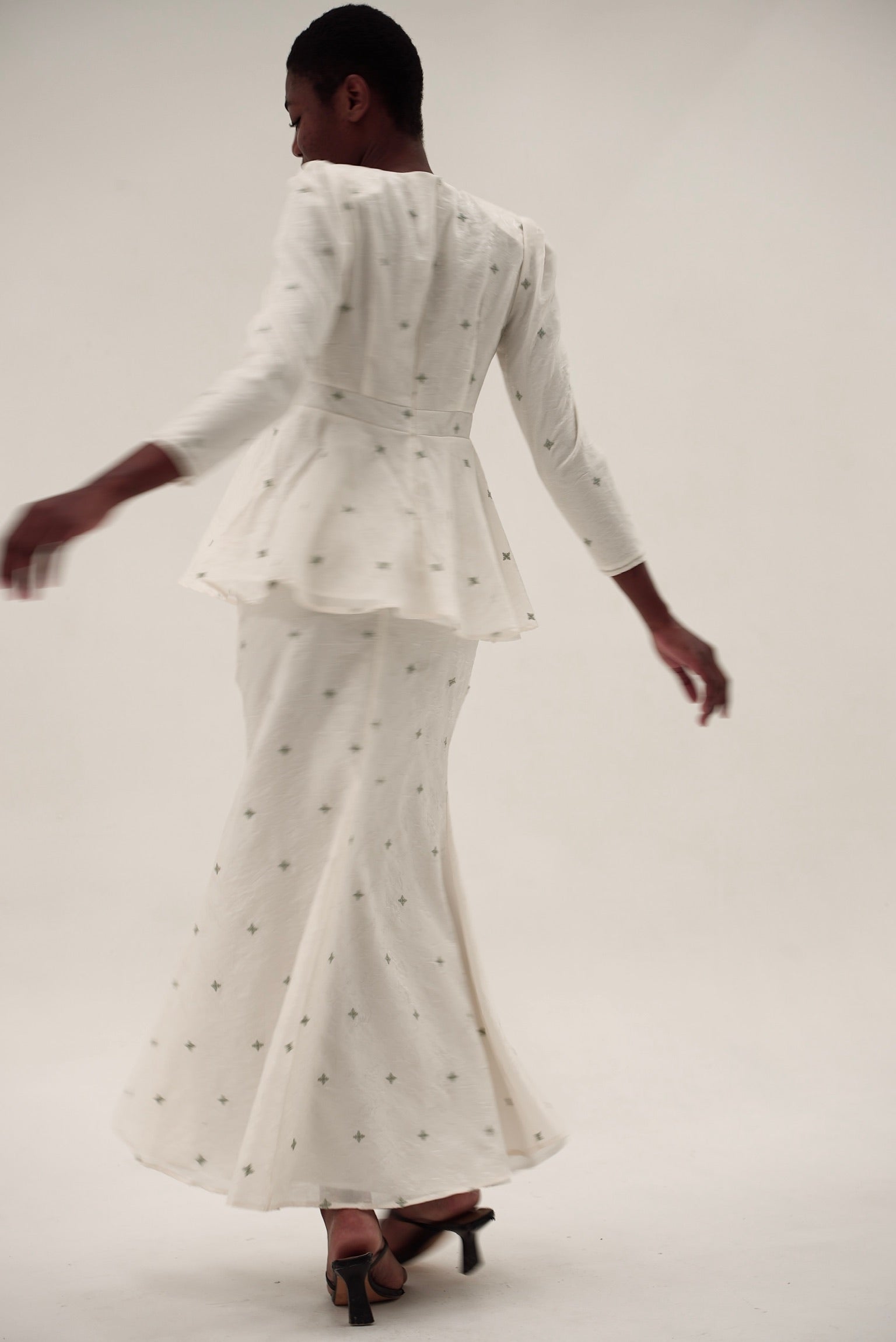 Kurung Lara peplum kurung set in motion with flowing skirt and structured bodice