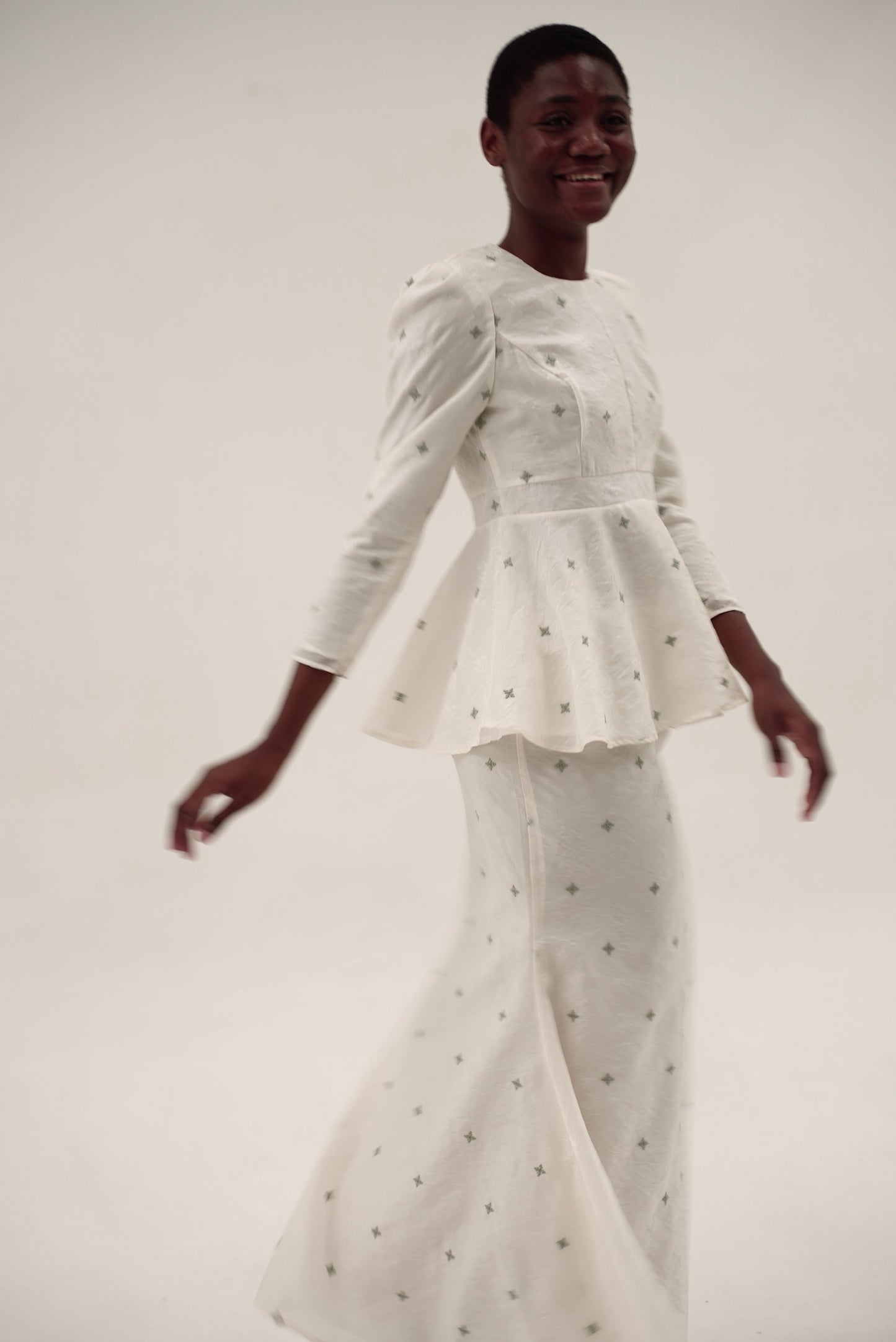 Detail of Kurung Lara showing contoured bodice and subtle sheen fabric with motif